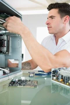 Handsome stern computer engineer working at open computer Stock Photos
