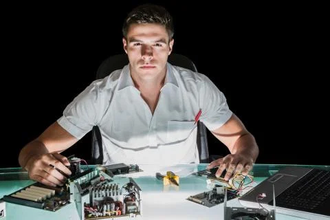 Handsome stern computer engineer working by night Stock Photos