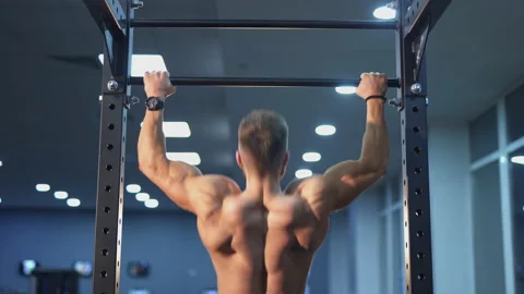 Handsome strong athletic man pumping up back muscles. Fitness man Stock Footage 153257761