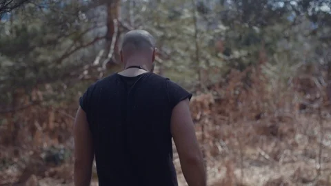 Handsome strong lumberjack holding axe in forest and enjoying with his dog Stock Footage 87565579