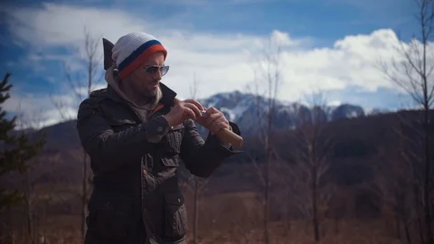Handsome strong lumberjack holding axe in forest and enjoying with his dog Stock Footage 87565872