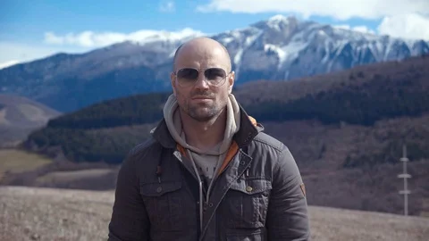 Handsome strong lumberjack posing and enjoying his day with mountains background Stock Footage 87569125