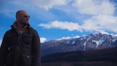 Handsome strong lumberjack posing and enjoying his day with mountains background Stock Footage 87569670