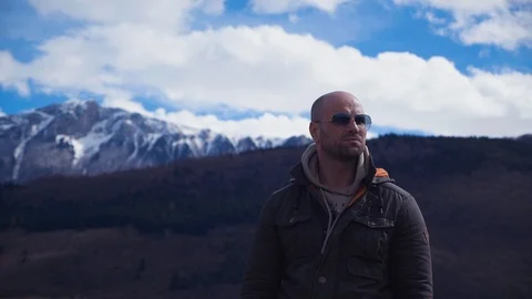 Handsome strong lumberjack posing and enjoying his day with mountains background Stock Footage 87569811