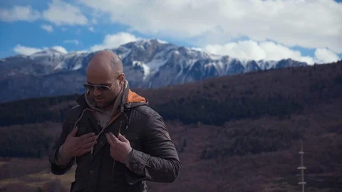 Handsome strong lumberjack posing and enjoying his day with mountains background Stock Footage 87570067