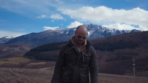 Handsome strong lumberjack posing and enjoying his day with mountains background Stock Footage 87570073