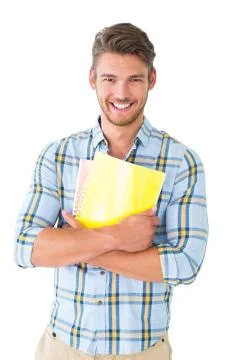Handsome student holding notepad smiling at camera Stock Photos