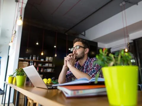 Handsome student studying in restaurant Stock Photos