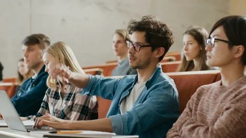 Handsome Student Uses Laptop while Listening to a Lecture at the University. Stock Footage
