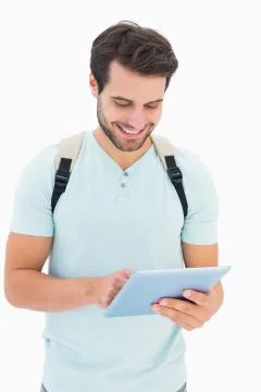 Handsome student using his tablet pc Stock Photos
