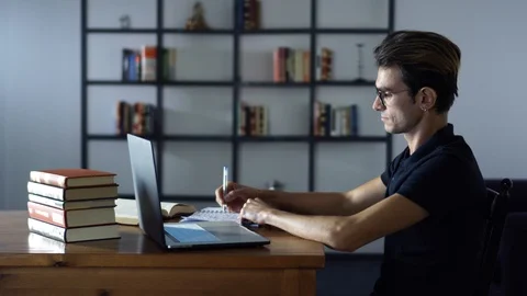 Handsome Student Writing and Finding New Information, Studying in the Library Stock Footage 93301262