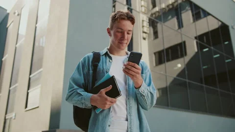 Handsome student young man with red hair walking down the stairs near university Stock Footage 142049671