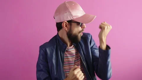 Handsome stylish bearded man dancing having fun on pink background Stock Footage 120912830