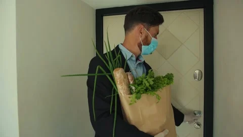 Handsome stylish man coming back home after food shopping entering house taking Stock Footage 132541398