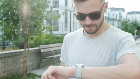 Handsome stylish young man using smartwatch Stock Footage 94059507