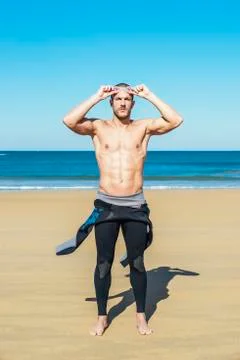 Handsome swimmer putting on goggles Stock Photos