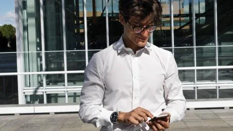Handsome trendy man using cell phone to type text Stock Photos