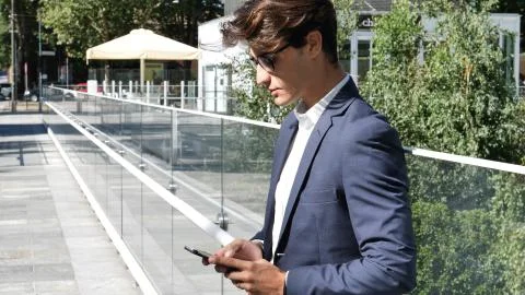 Handsome trendy man using cell phone to type text Stock Photos