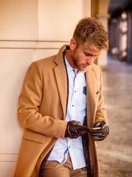 Handsome trendy man using cell phone to type text Stock Photos