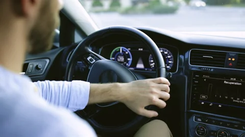 Handsome unrecognizable bearded man driving electric car commuting to work 스톡 동영상 200837996