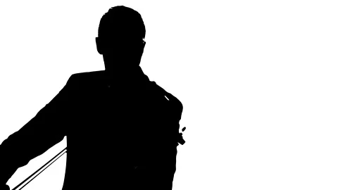 Handsome violinist playing on a classical violin. Silhouette Stock Footage 134522573