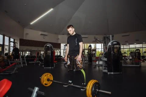 Handsome weightlifter preparing for training. Shallow depth of field, selecti Stock Photos