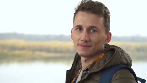 Handsome white man looking at camera, close up, outdoor in morning nature Stock Footage 100890853