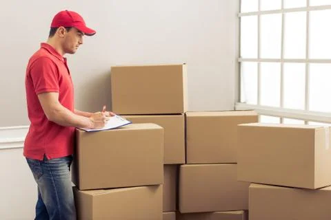 Handsome worker helping to move Stock Photos