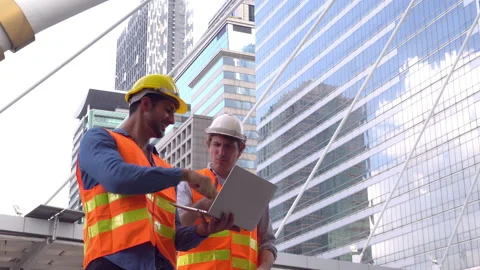 Handsome worker or engineer guy working on laptop and showing finished proje Stock Footage 137444241