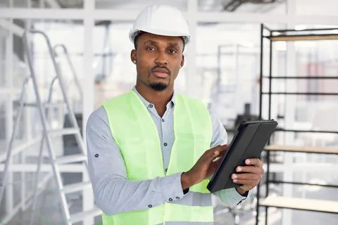 Handsome young african engineer using digital tablet at work Stock Photos
