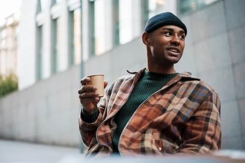 Handsome young african man drinking takeaway coffee Stock Photos