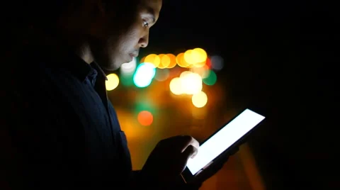 Handsome, young asain man with tablet computer in city at night Stock Footage 63560239