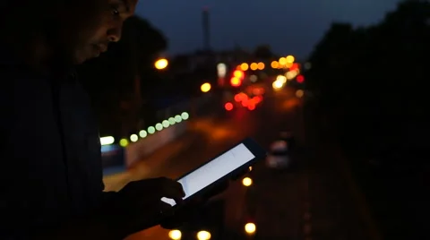 Handsome, young asain man with tablet computer in city at night Stock Footage 63561964