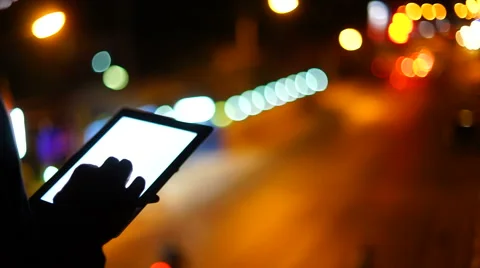 Handsome, young asain man with tablet computer in city at night Stock Footage 63562886
