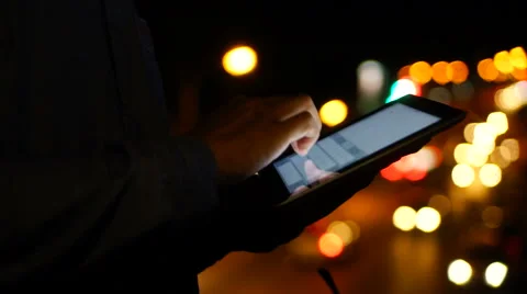 Handsome, young asain man with tablet computer in city at night Stock Footage 63564361