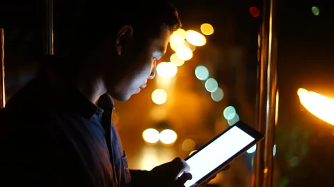 Handsome, young asain man with tablet computer in city at night Stock Footage 63571674