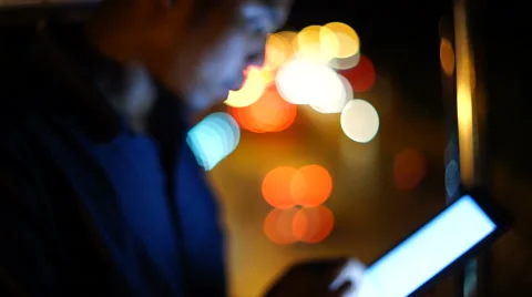 Handsome, young asain man with tablet computer in city at night Stock Footage 63577236
