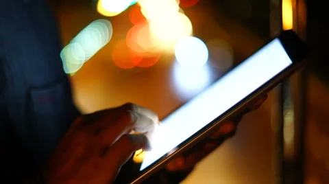 Handsome, young asain man with tablet computer in city at night Stock Footage 63579709