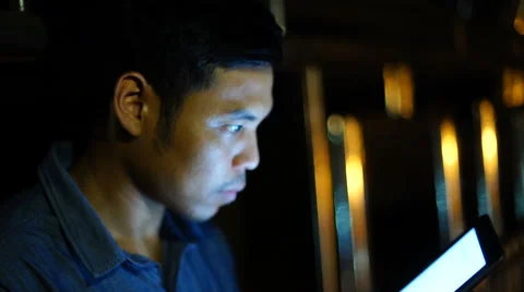 Handsome, young asain man with tablet computer in city at night Stock Footage 63583091