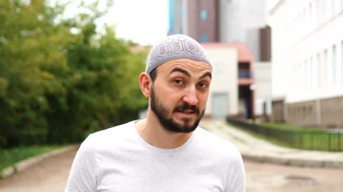 Handsome young bearded man saying no by shaking head outdoors. Stock Footage 113974409
