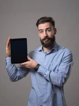 Handsome young bearded programmer advertising application software on blank b Stock Photos