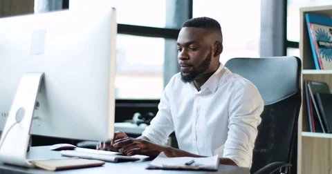 Handsome young black man working use computer feels frustrated in office Stock Footage 81951414