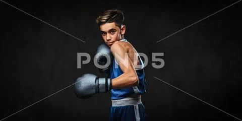 Handsome young boxer during boxing exercises, focused on process. Isolated on Stock Photos