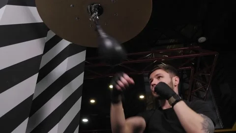 Handsome young boxer exercising with the speed boxing bag at the gym. Stock Footage 150266896