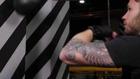 Handsome young boxer exercising with the speed boxing bag at the gym. Stock Footage 150344546