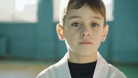 Handsome young boy looking and sincerely smiling at camera in the gym 4K Video stock 75390644
