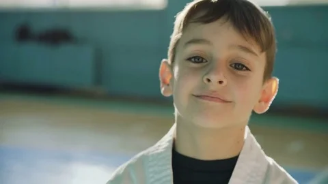 Handsome young boy looking and sincerely smiling at camera in the gym 4K 스톡 동영상 75390805