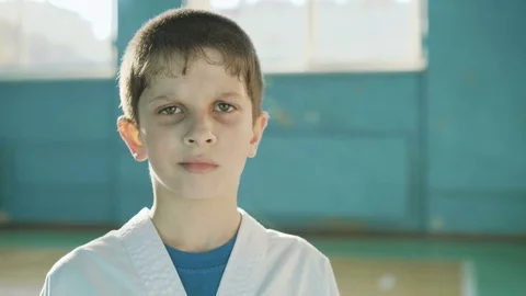 Handsome young boy looking and sincerely smiling at camera in the gym 4K Stock Footage 75391067