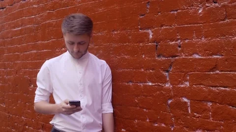 Handsome young business man using smartphone happy outdoors. Man texting using Video stock 66456661