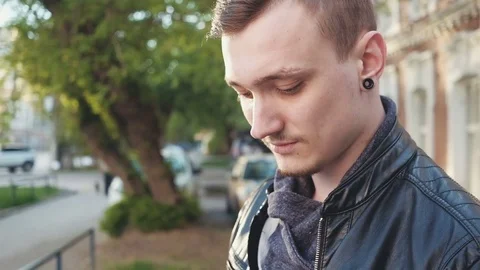 Handsome young business man using smartphone smiling outdoors. Sunny day Stock Footage 75891863